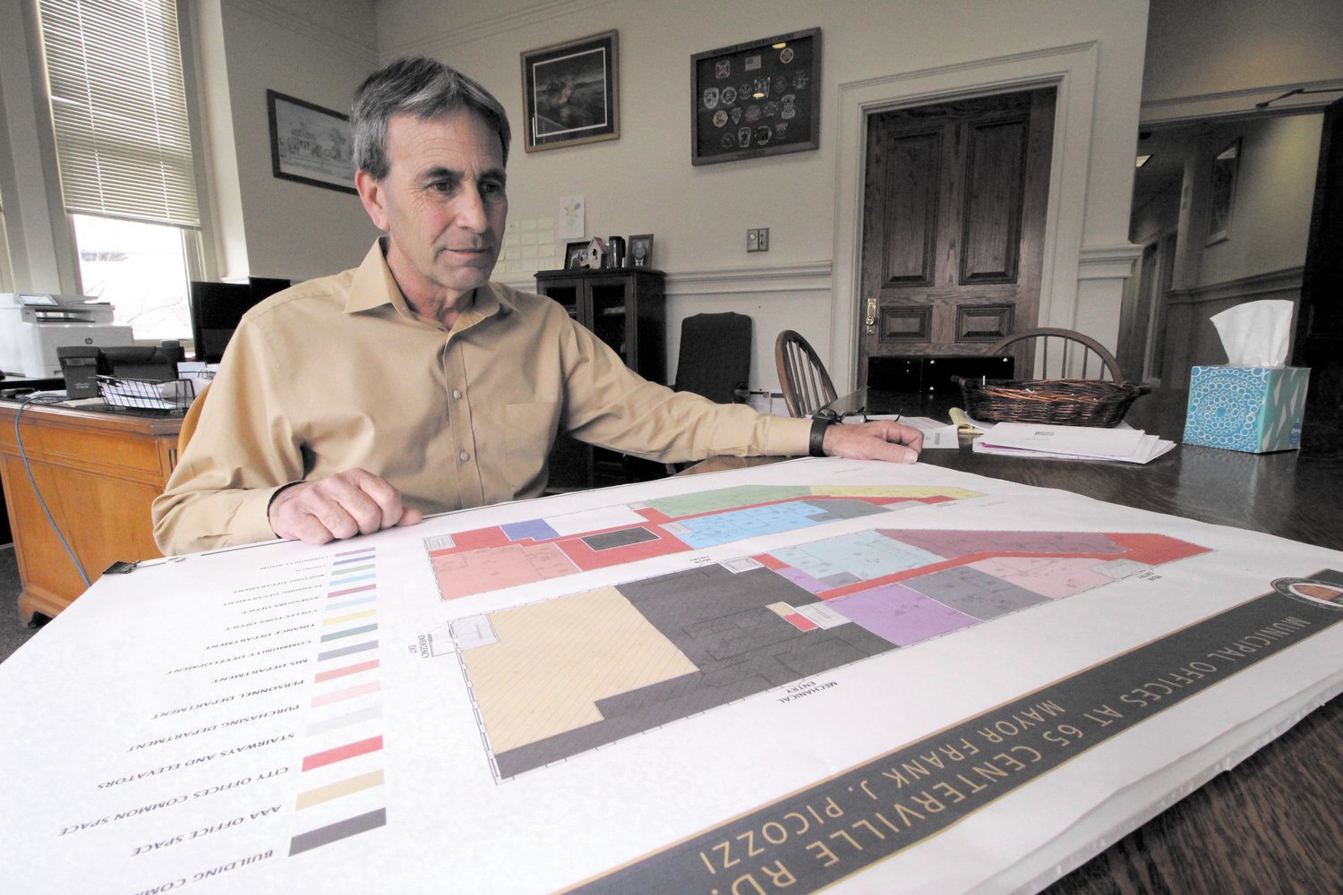 PALNNING AHEAD: Mayor Frank Picozzi looks over the office plans for the City Hall Annex to be located in the former Apponaug Mill saw tooth building owned by AAA Northeast. The offices are projected to be ready this summer. (Warwick Beacon photo)